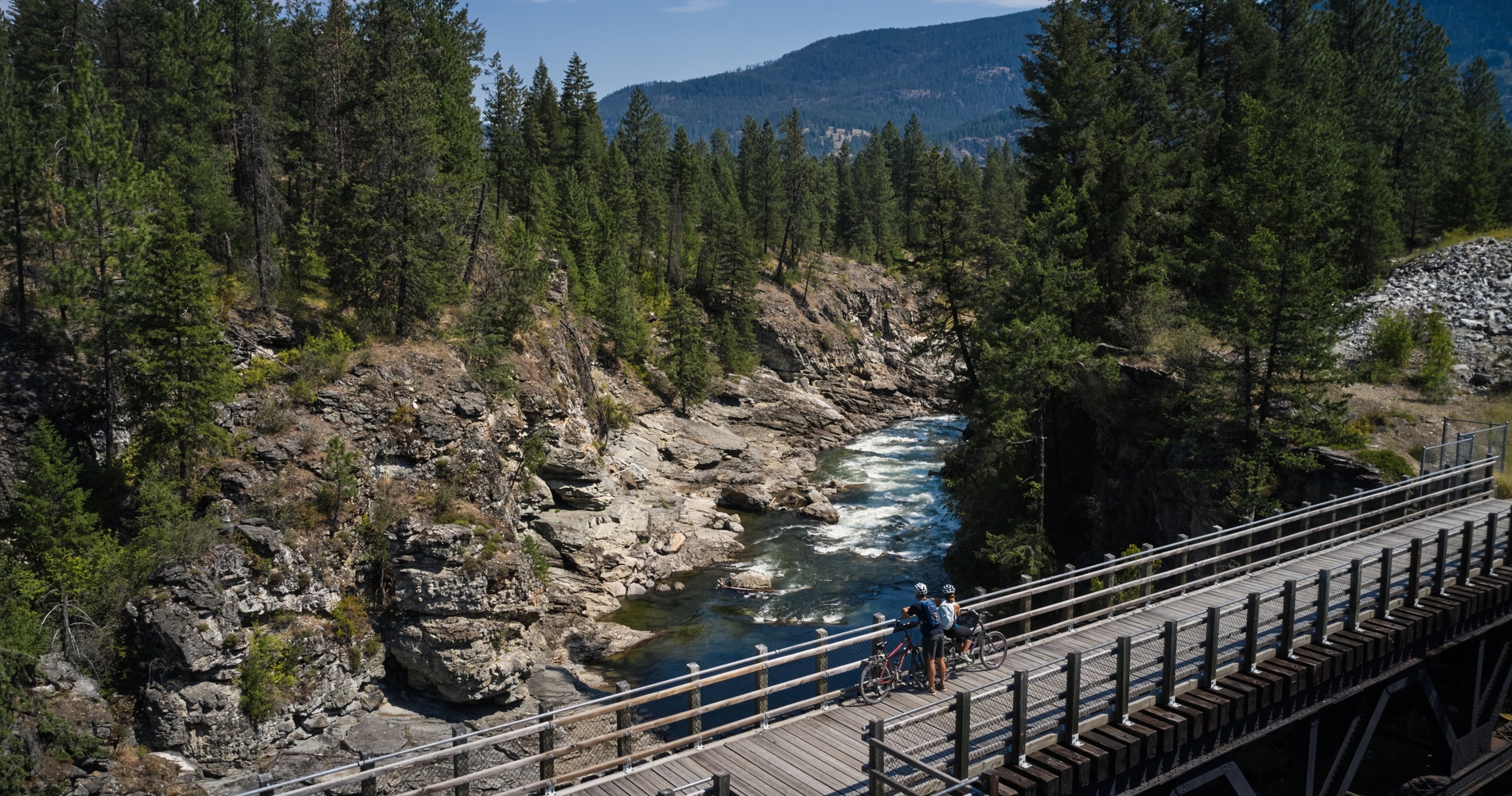 Biking on a trestle bridge on the Kettle Valley Trail in Christina Lake | 