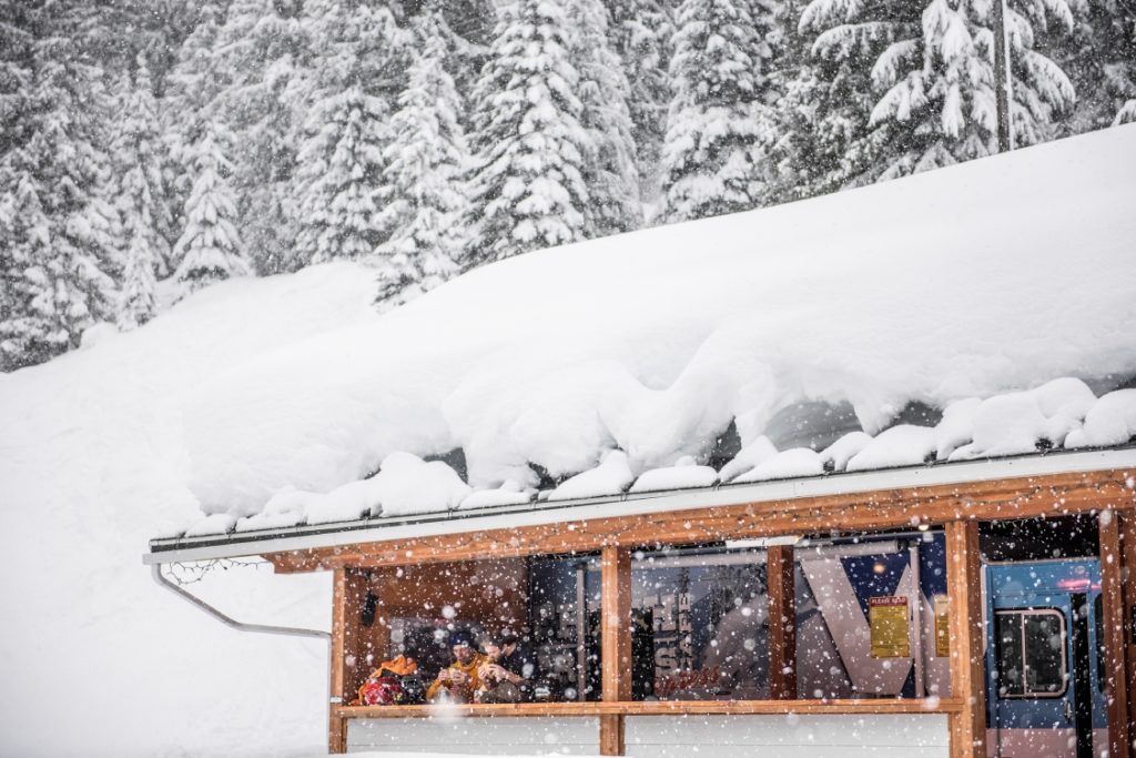 Skiers sit on the patio of the Fresh Tracks Cafe in the winter.