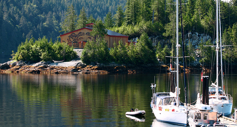 man on boat near beautiful lakehouse