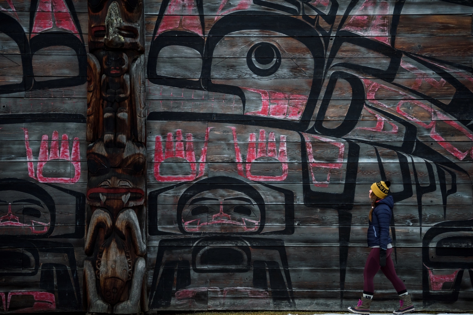 A person walks by the ‘Ksan Historical Village and Museum