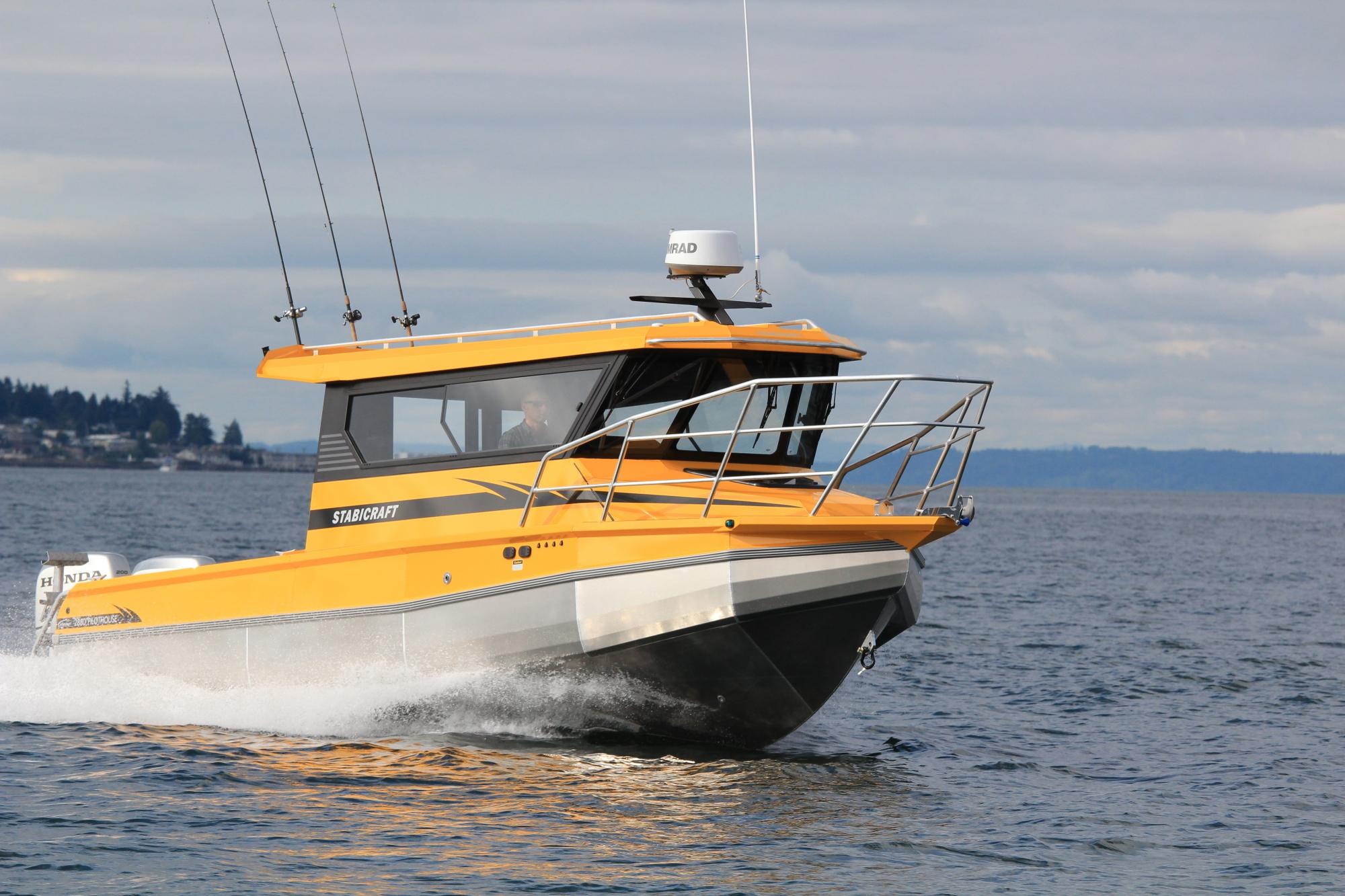 A yellow boat races across the ocean