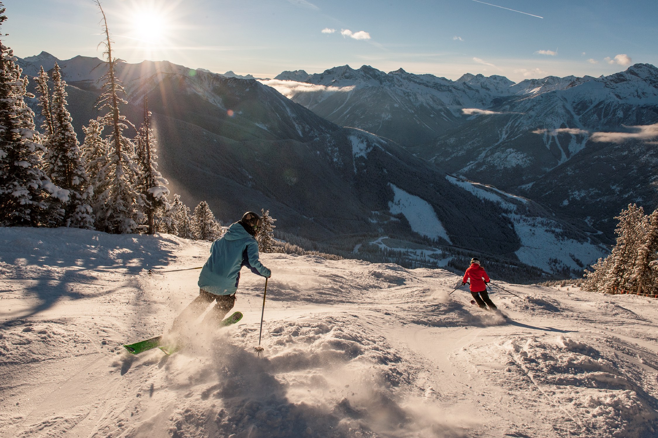 Two Skiers head downhill from the snowy alpine at Panorama Mountain Resort