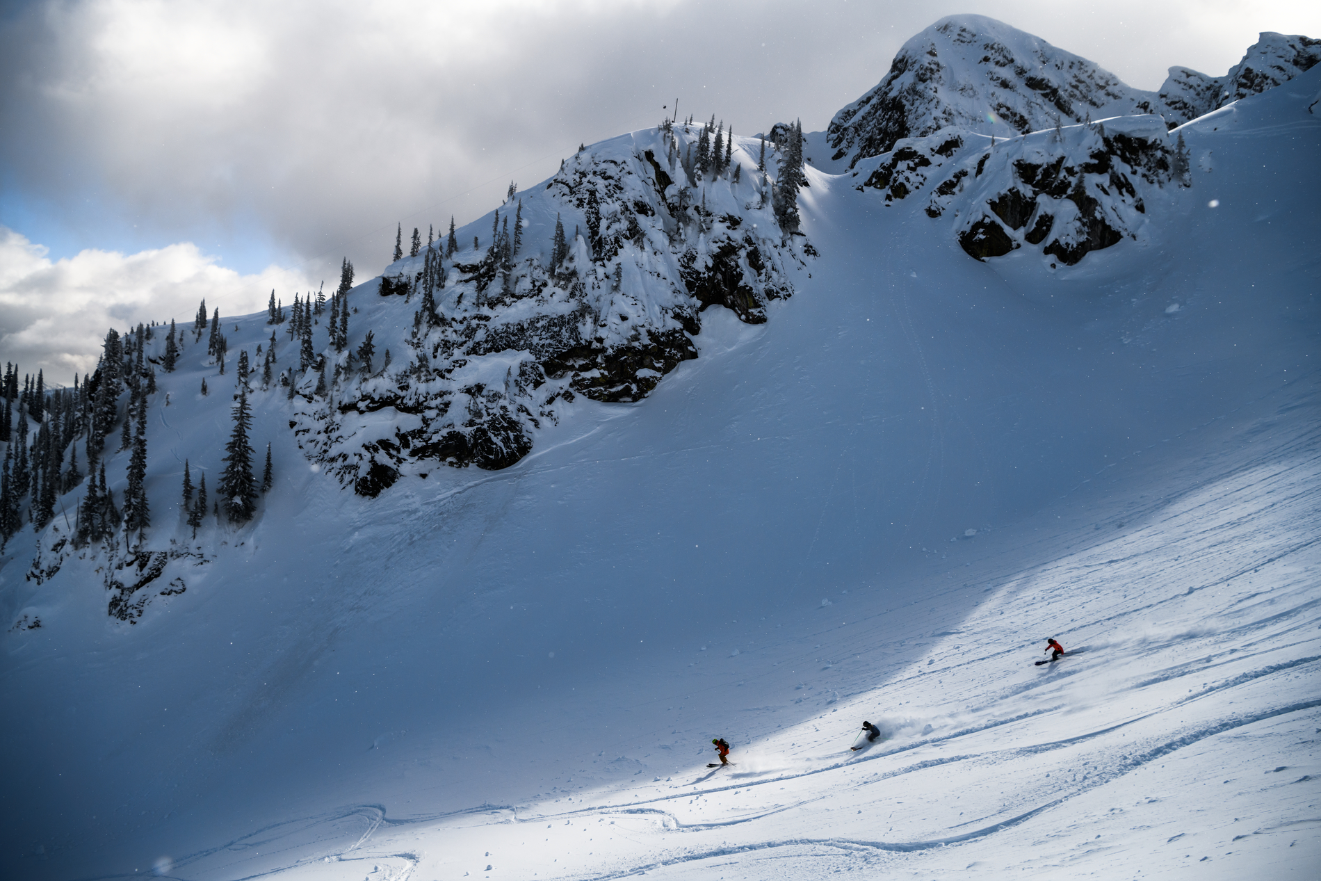A trio of skiers and snowboarders in Revelstoke Mountain Resort's North Bowl | Andrew Strain