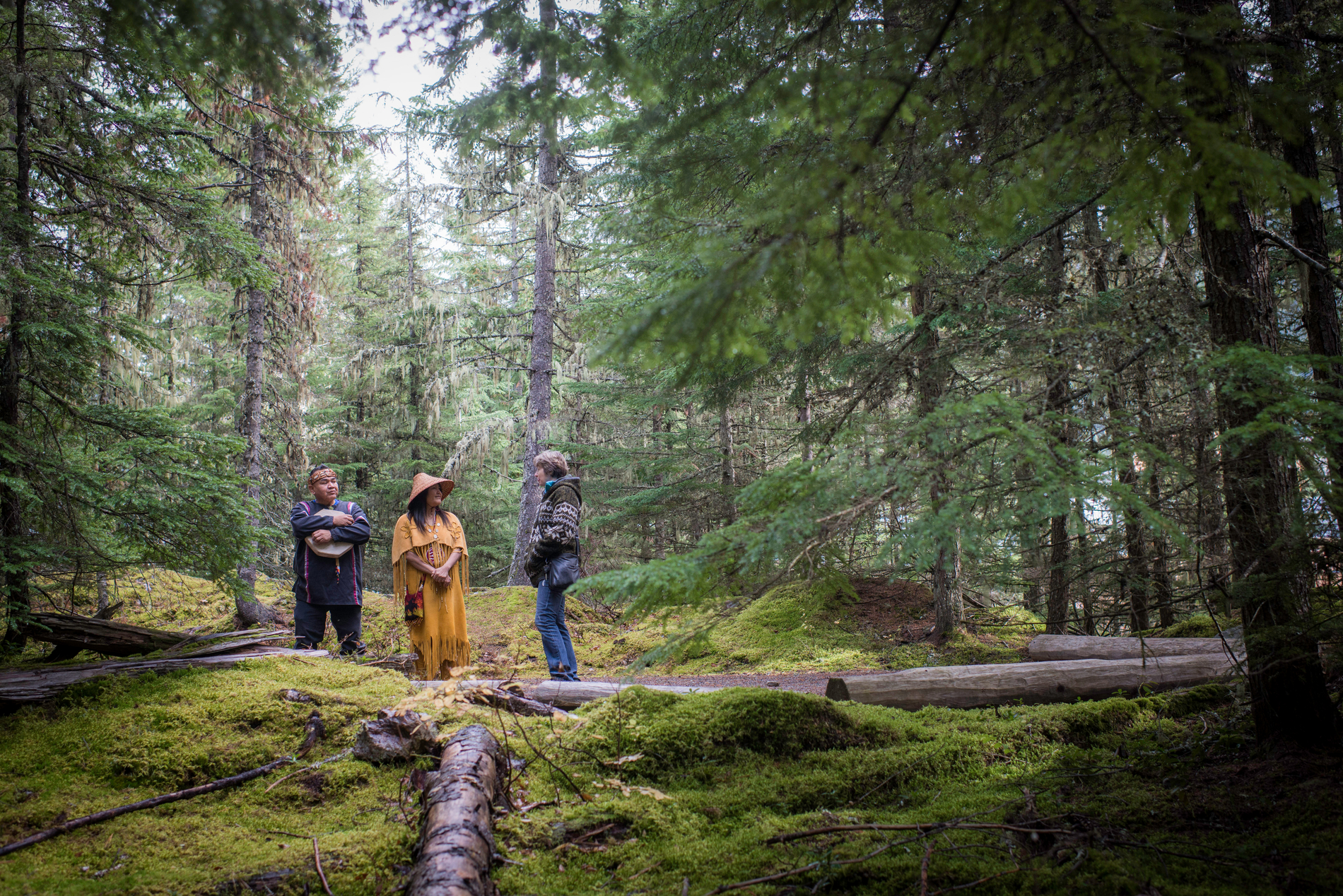 Cultural Ambassador in regalia in the woods on the Forest Walk from the Squamish Lil'wat Cultural Centre in Whistler