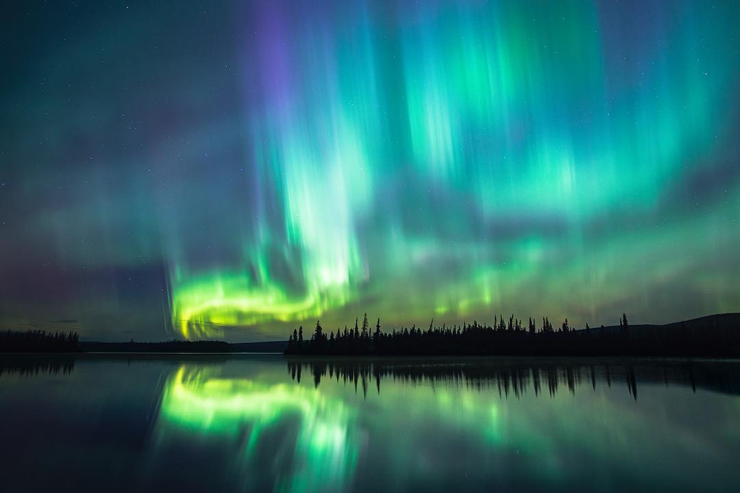 The Northern Lights in the sky over a lake on the Cariboo Chilcotin Coast