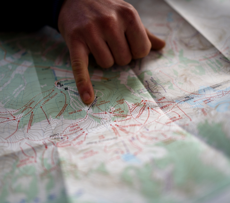 A person's hand points to a map of Terrace