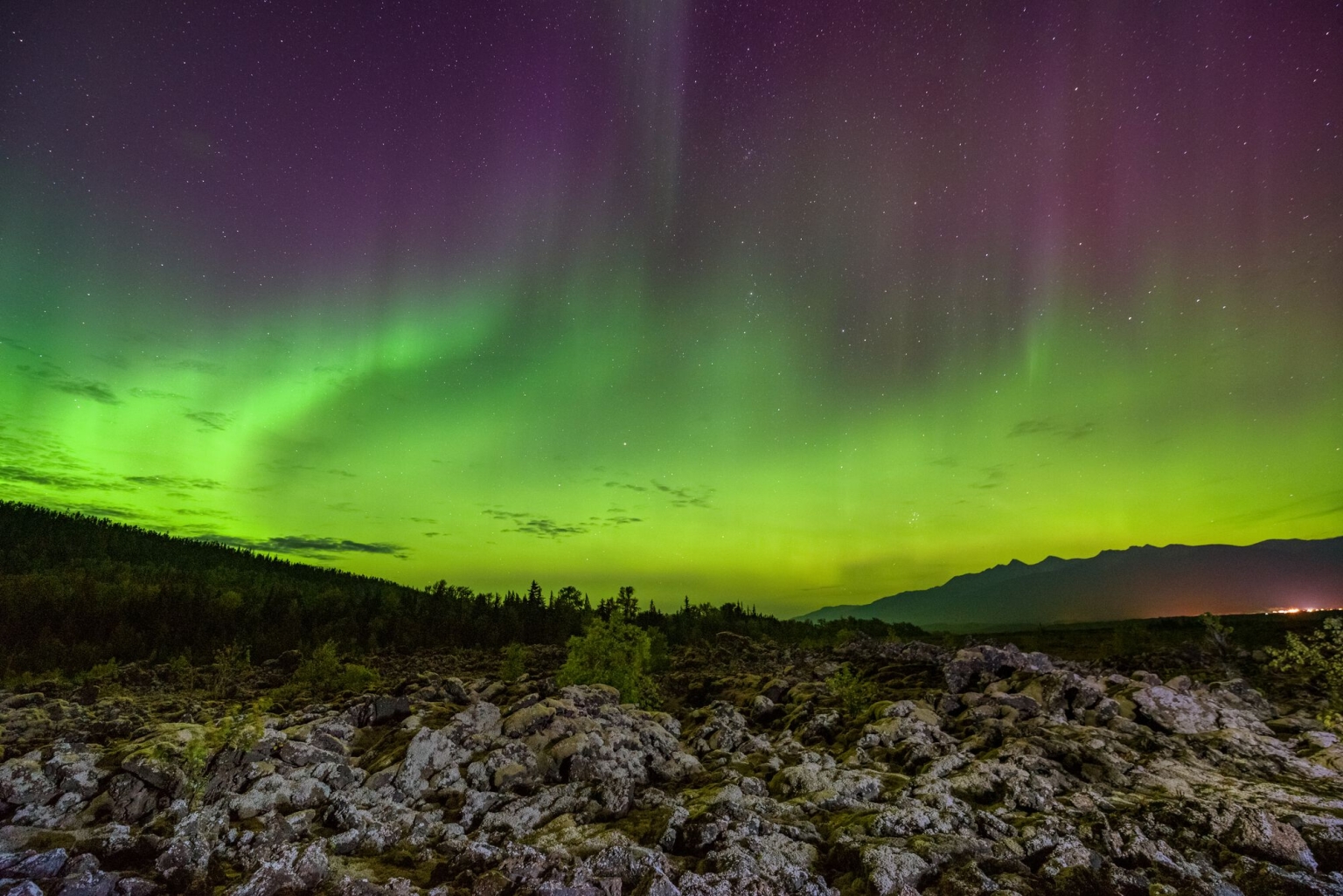 The green and purple Northern Lights illuminate the sky in 