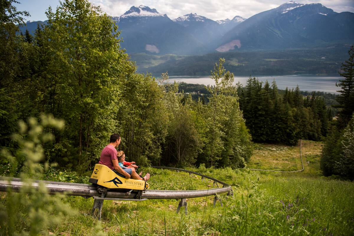 A parent and child enjoy The Pipe Mountain Coaster at Revelstoke Mountain Resort in Revelstoke, BC.